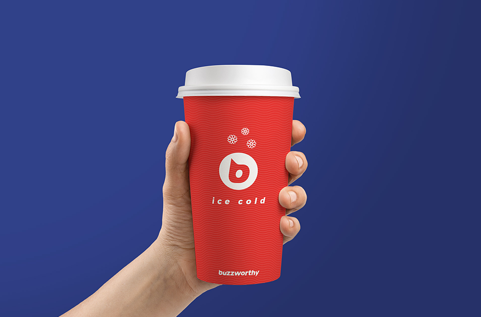 hand holding a buzzworthy branded paper cup