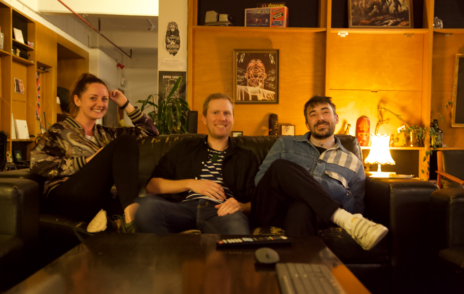 photo of a girl and 2 boys from resn sitting on a sofa smiling